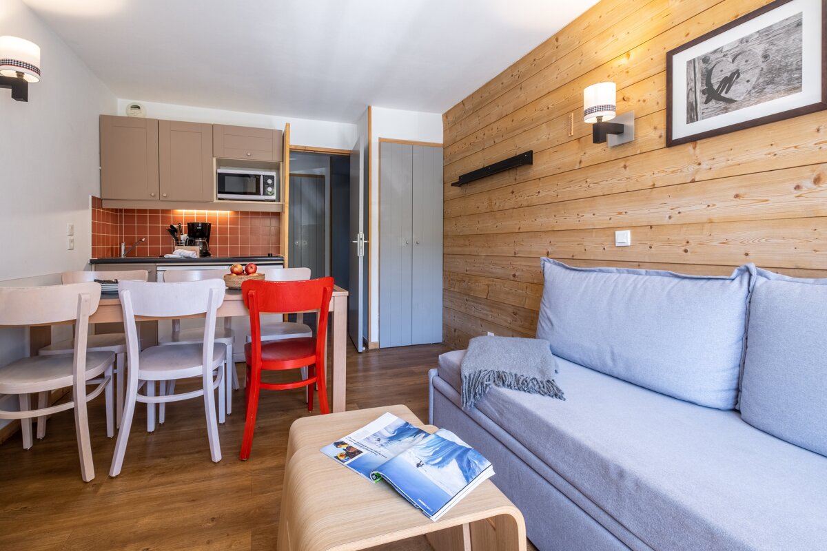 A living room with a couch and a book on a table