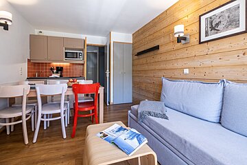 A living room with a couch and a book on a table