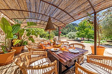 A table with plates of food on it under a canopy