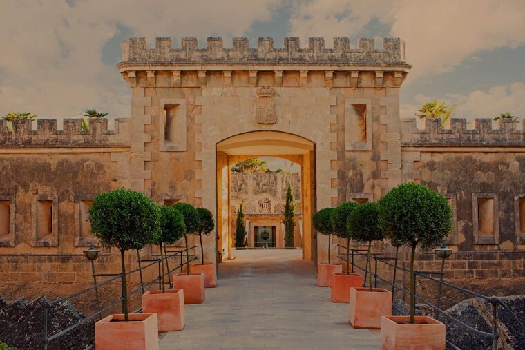 A stone archway with a coat of arms on it