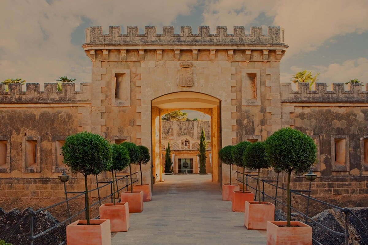 A stone archway with a coat of arms on it