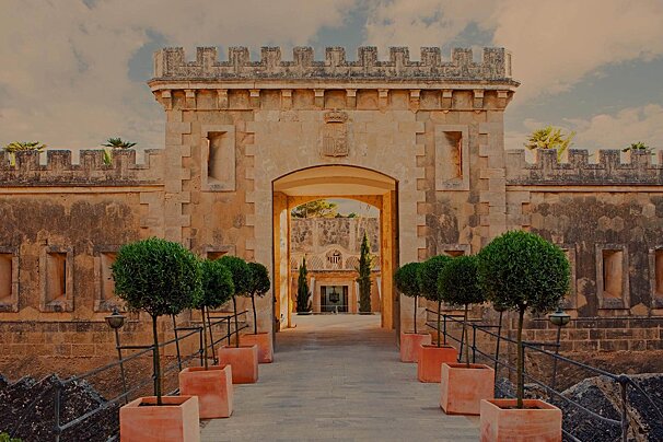 A stone archway with a coat of arms on it