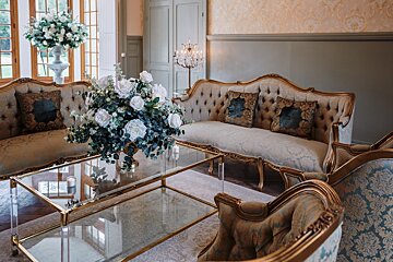 A living room with a couch and a glass coffee table