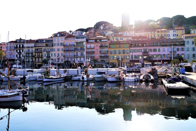the old port of cannes with suquet in the background
