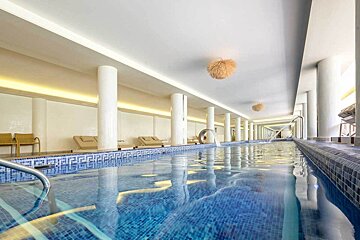 A large indoor swimming pool with blue tiles