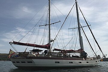 A sailboat with a spanish flag on the side of it