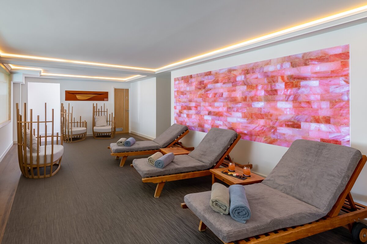 A room with chairs and a pink wall