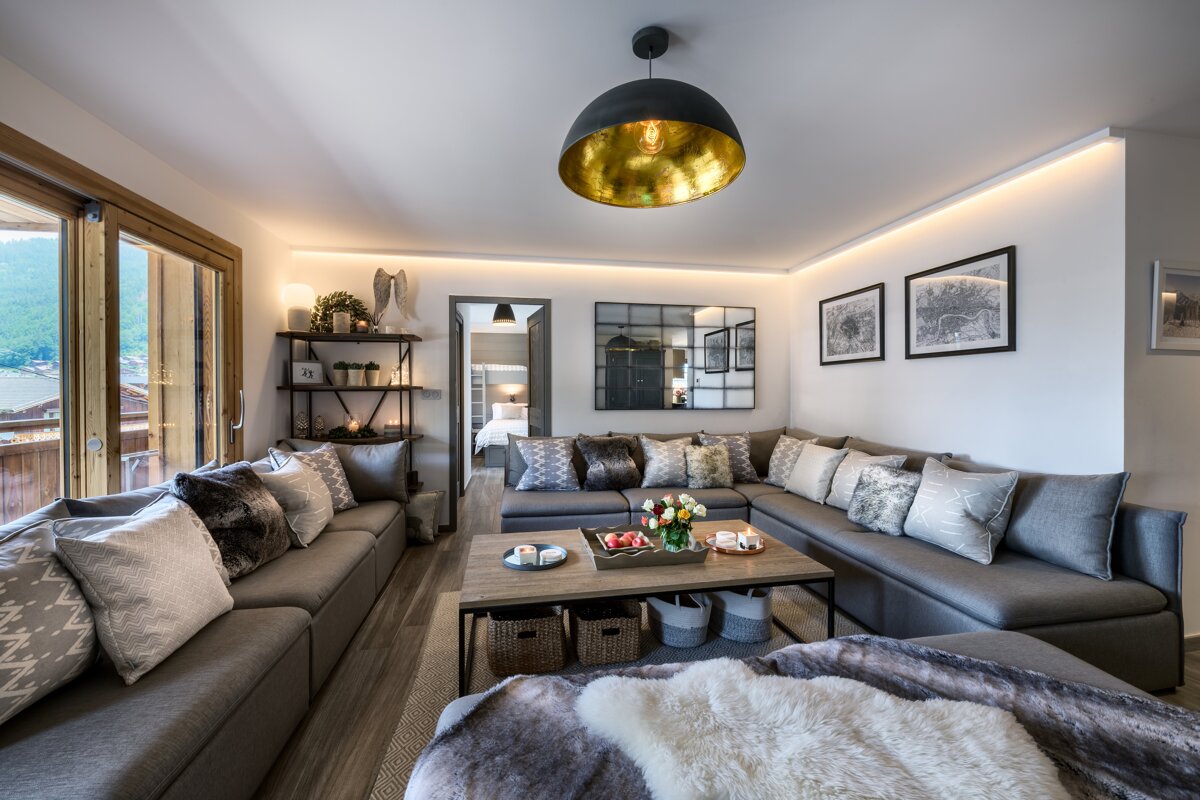 A living room with a large sectional couch and a coffee table