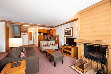 A living room with a couch and chairs and a fireplace
