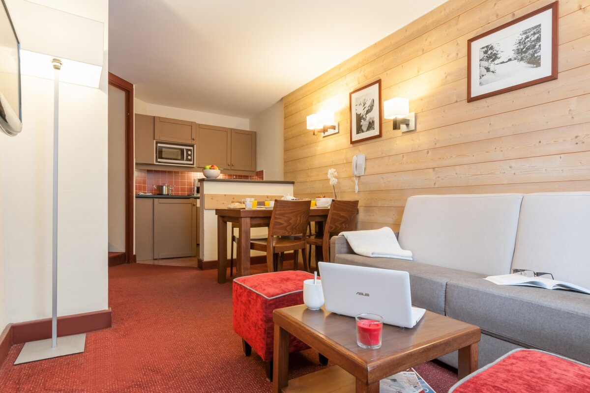 A living room with an asus laptop on a table