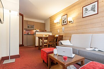 A living room with an asus laptop on a table