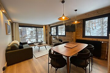A living room with a table and chairs and a couch