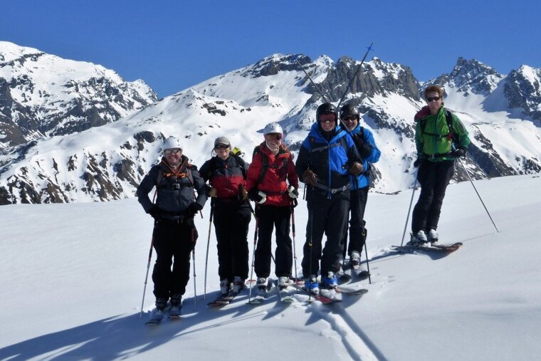 a team of skiers off piste