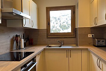 A kitchen with a stove top oven and a toaster