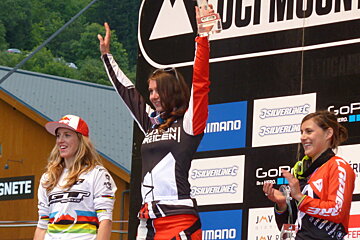 three women mountain bikers on a podium