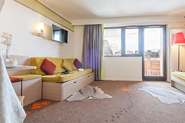 A living room with a couch and a television