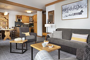 A living room with a couch a chair and a table