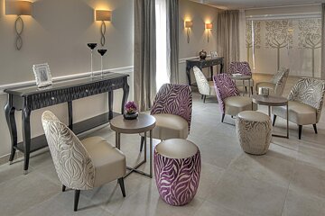 A room with chairs and tables and a picture on the wall