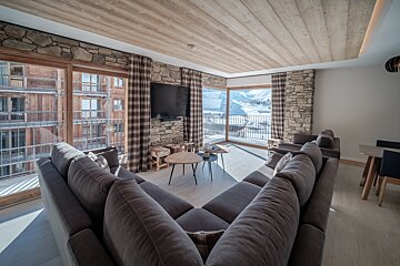 A living room with a couch and a flat screen tv