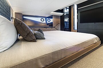 A bedroom with a large bed and a television