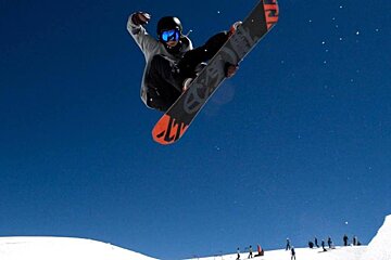 a snowboarder jumping in a pipe