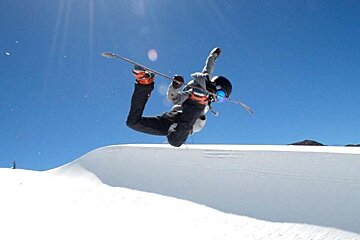 a snowboarder jumping in a pipe