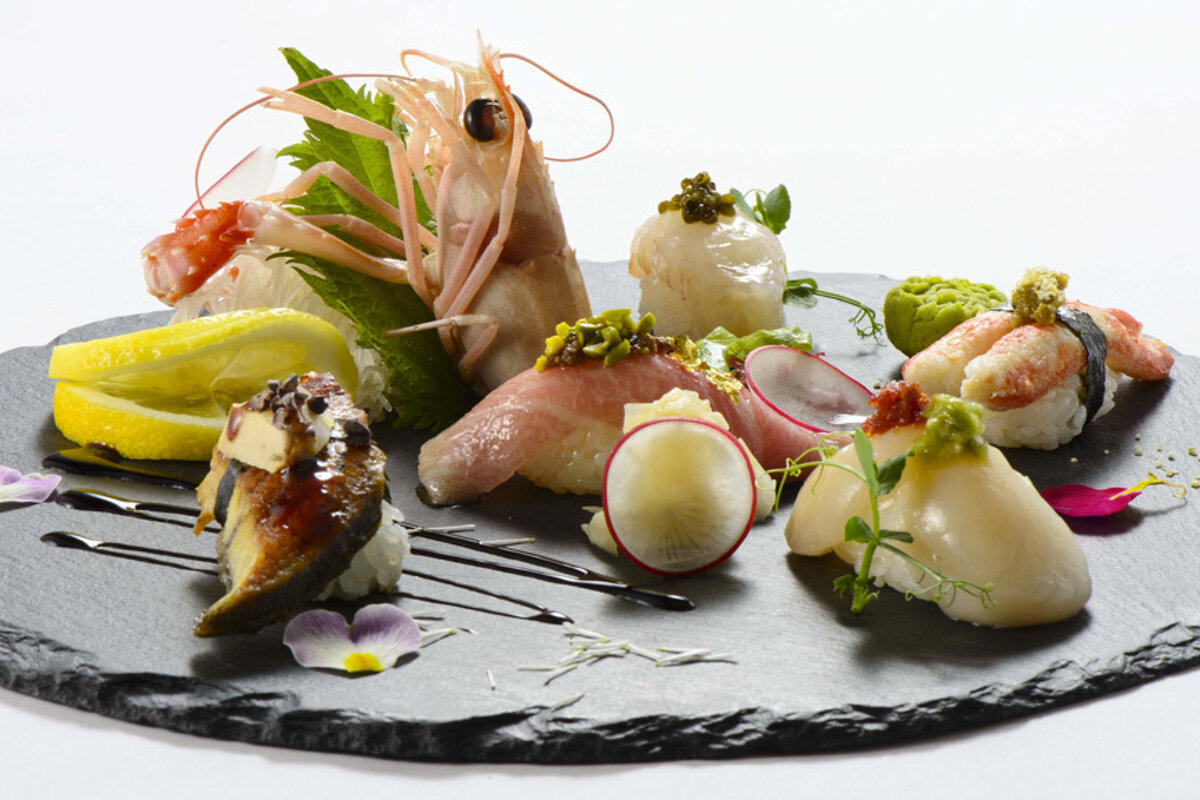 A slate plate with a variety of food on it