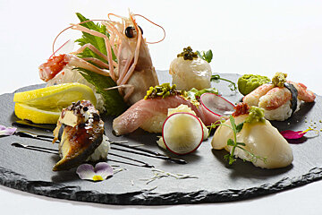A slate plate with a variety of food on it
