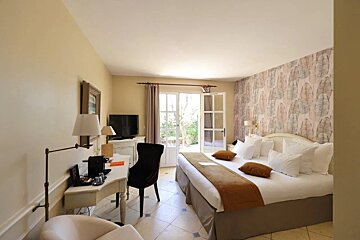 A hotel room with two beds and a desk