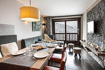 A dining room table with plates and glasses on it