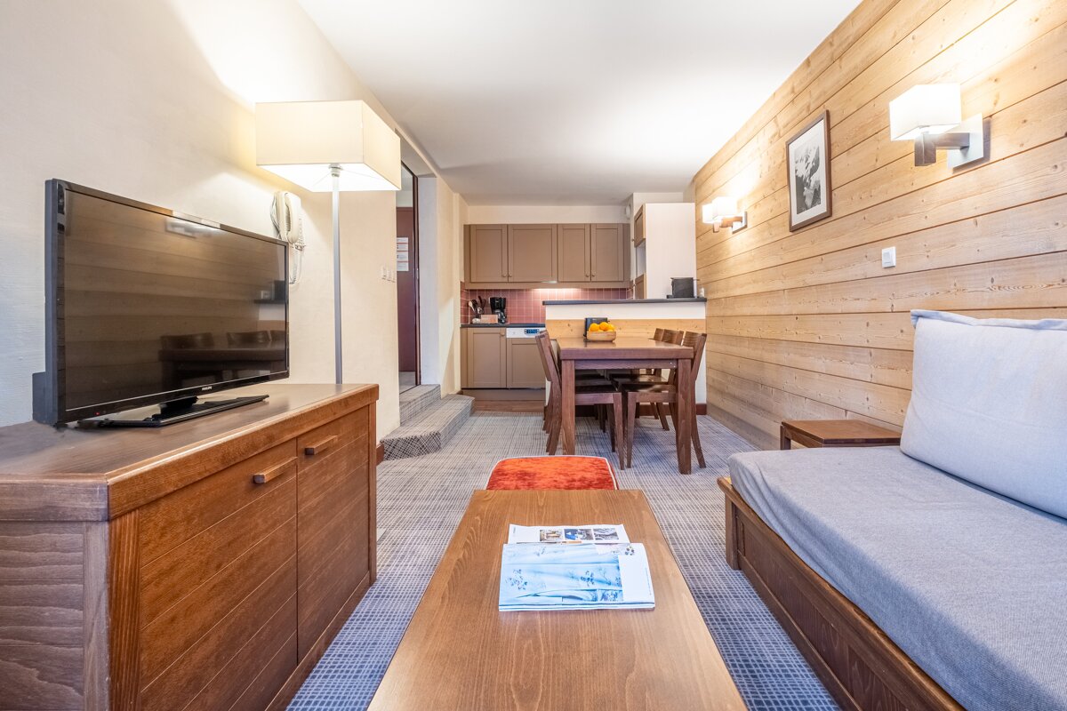 A living room with a couch and a flat screen tv