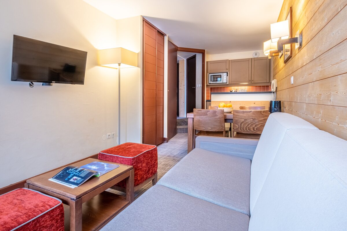 A living room with a couch a table and a flat screen tv