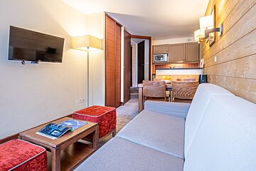 A living room with a couch a table and a flat screen tv