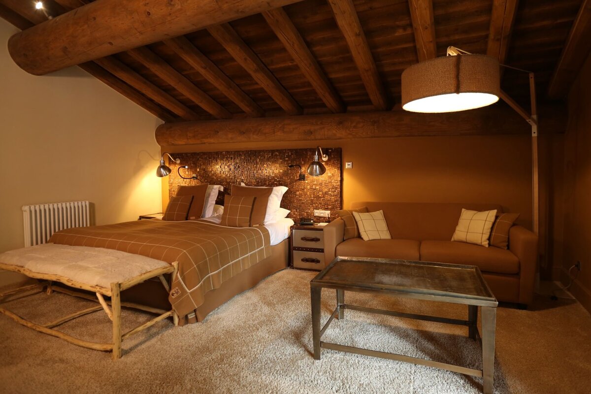 A bedroom with a large bed and a couch