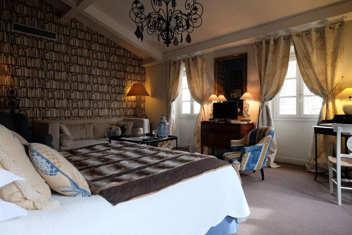 A bedroom with a large bed and a couch