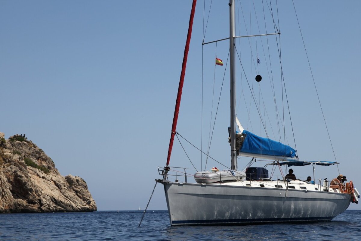 A sailboat with a spanish flag on the mast