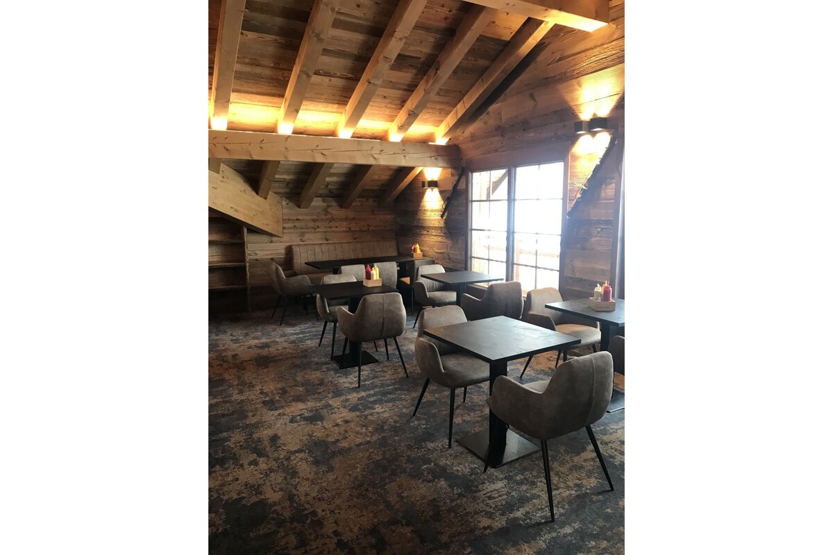 Tables and chairs in a room with a wooden ceiling