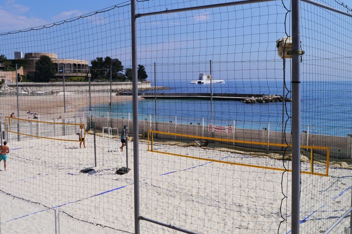 caged volleyball court on Plage du Larvotto Beach