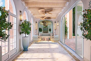 A hallway with a couch and chairs and a ceiling fan