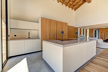 A kitchen with white cabinets and a large island
