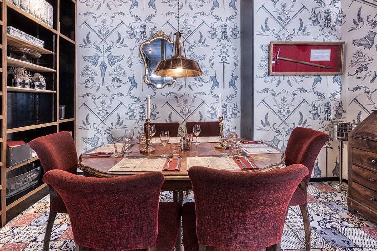 A dining room with red chairs and a table