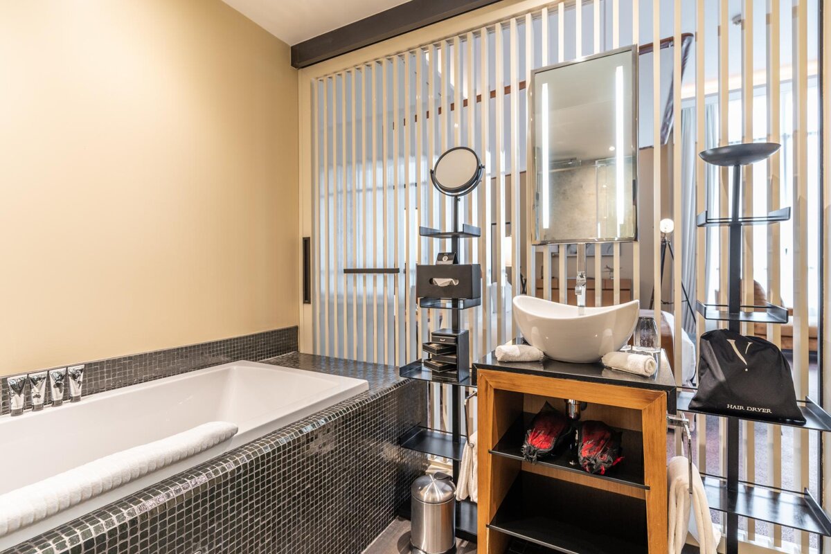 A bathroom with a bathtub and a sink and a bag that says ' abercrombie & fitch ' on it