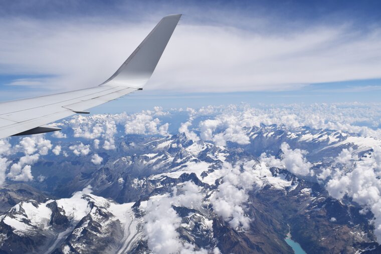 Plane over snow-capped mountains