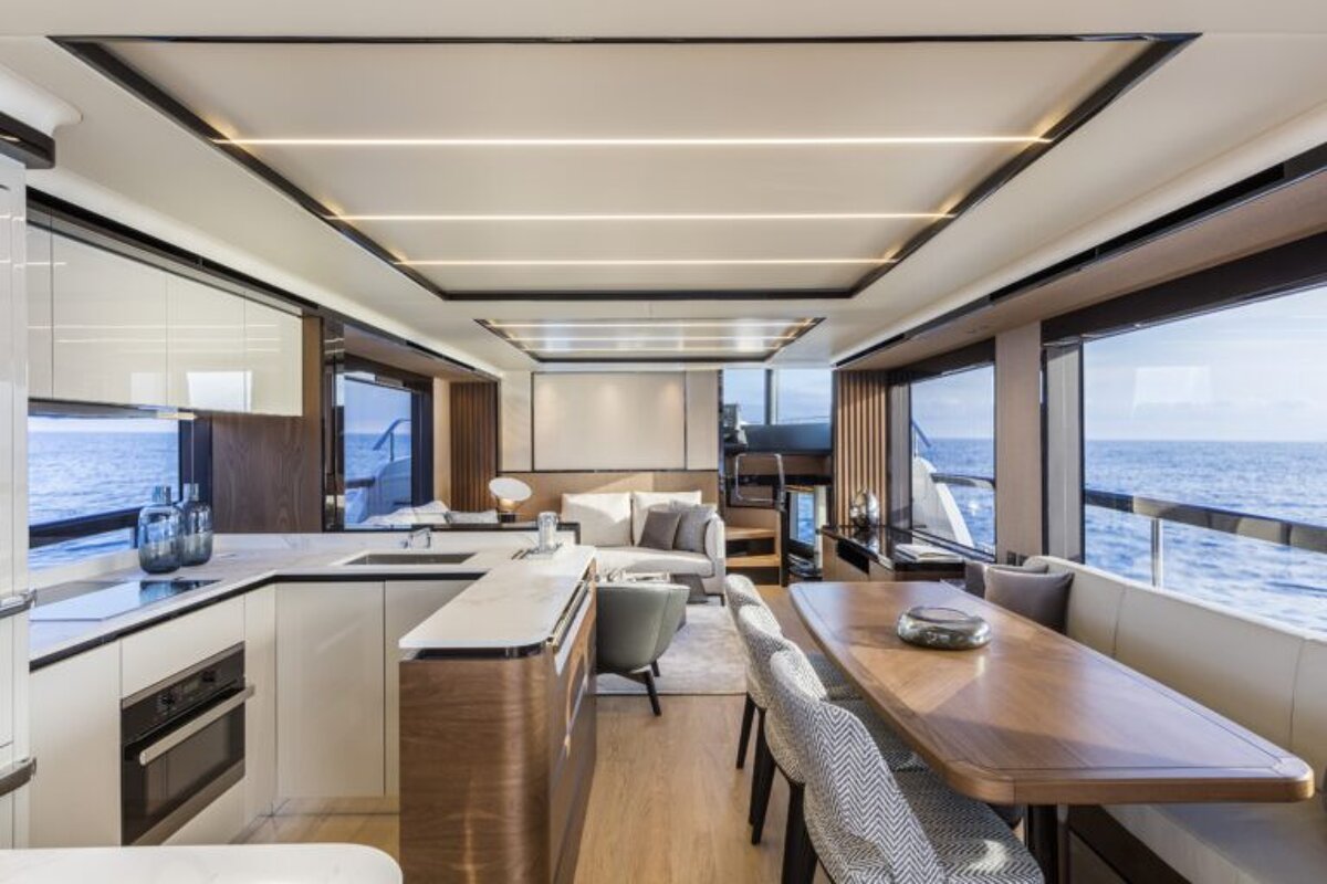 A kitchen and dining area on a boat with a view of the ocean