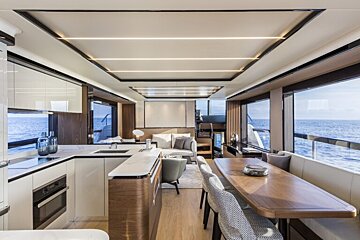 A kitchen and dining area on a boat with a view of the ocean