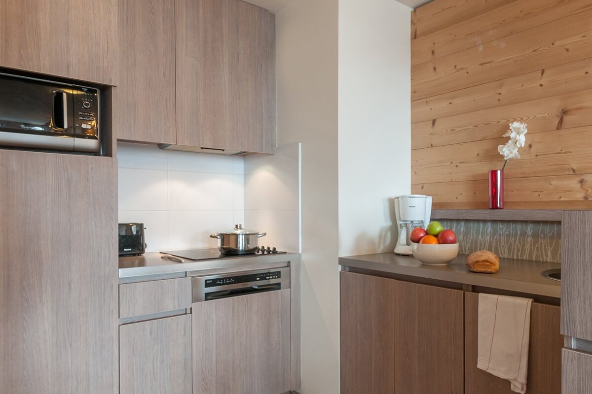 A small kitchen with a microwave and a dishwasher