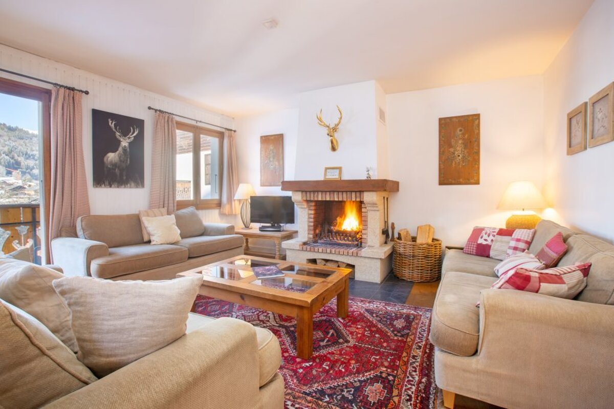 A living room with two couches and a fireplace