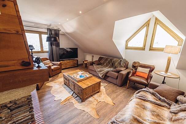 A living room with a couch a chair and a coffee table