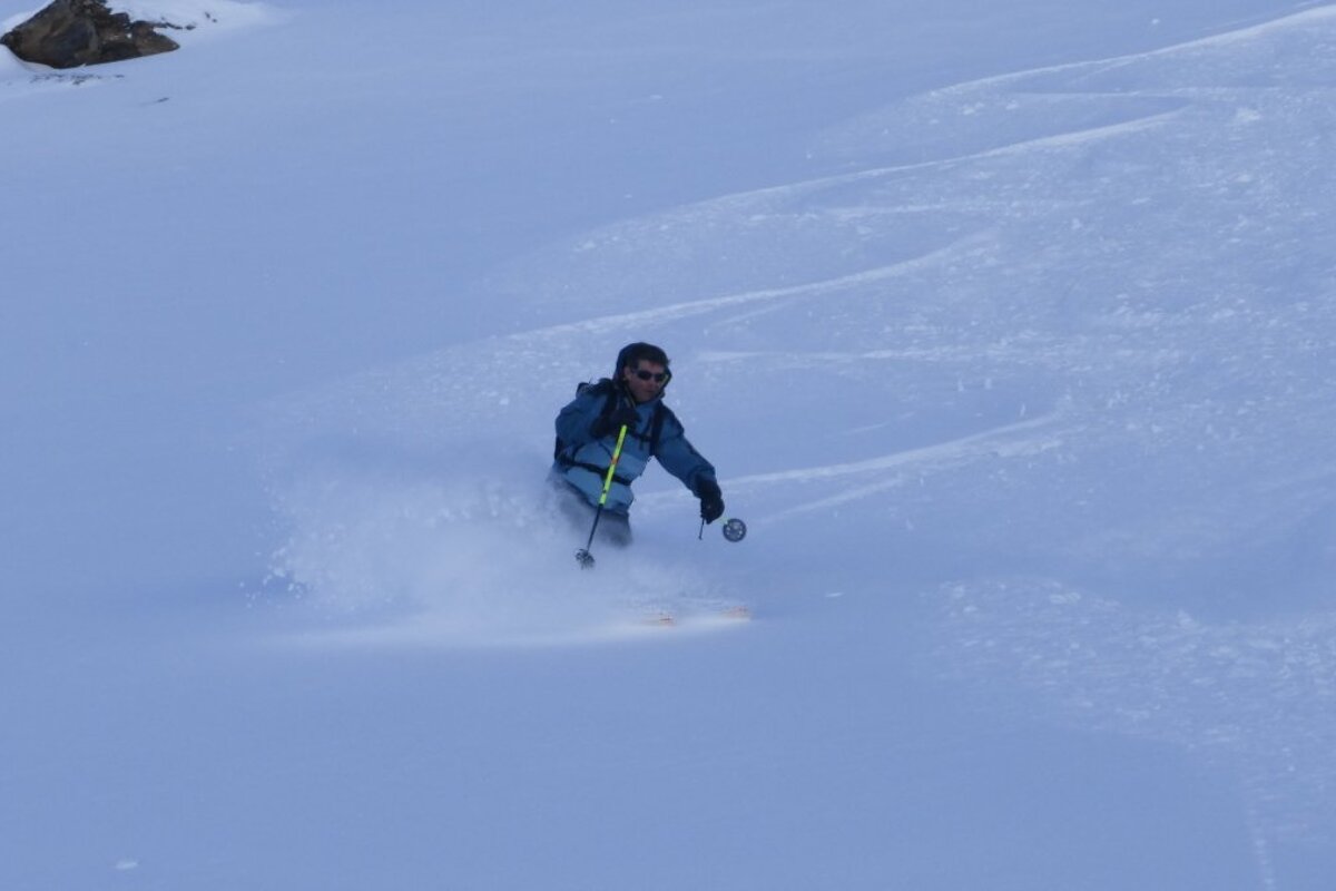 a male skier with no helmet on