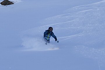 a male skier with no helmet on